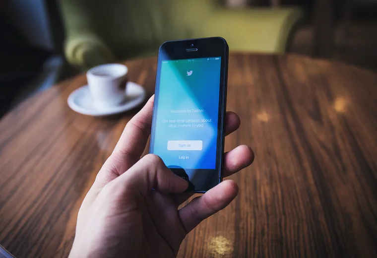 Ordering on a phone A smartphone next to a cup of coffee